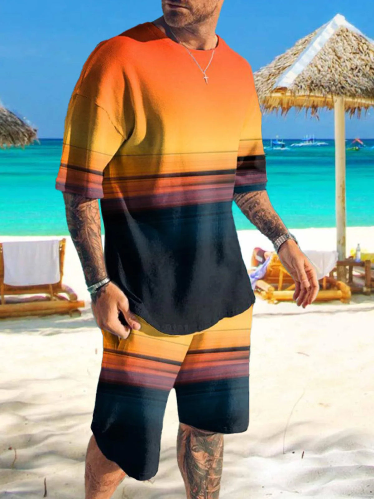 Man wearing orange-to-black gradient graphic shirt and matching shorts on a beach