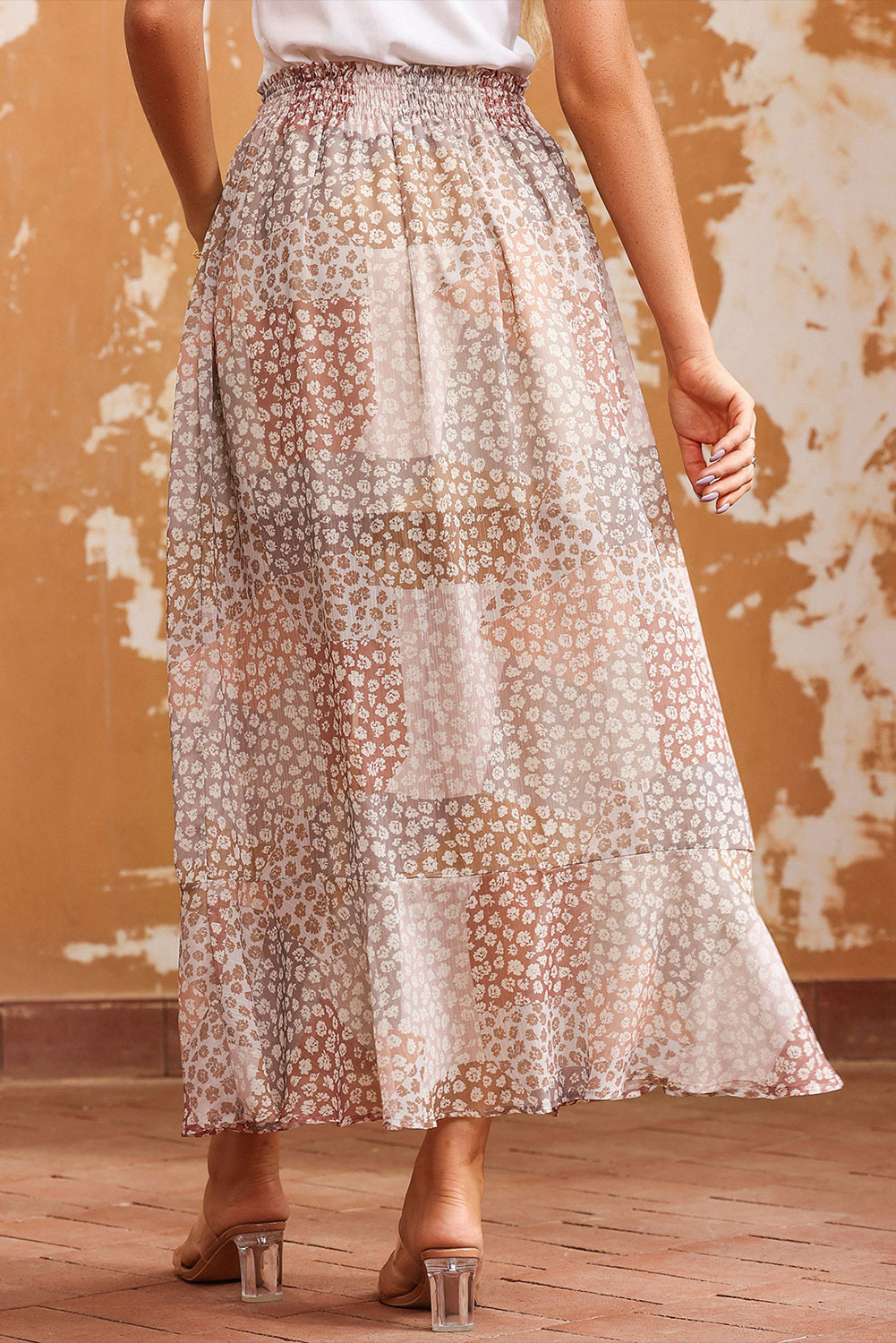 Back view of tiered floral midi skirt with smocked waistband