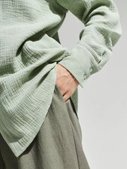 Close view of pale green shirt sleeve and gauze texture.