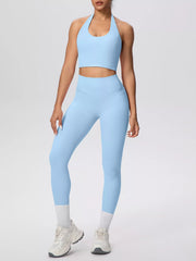 Angled front view of burgundy halter crop top and leggings