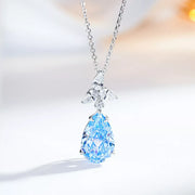 Pastel-blue teardrop zircon pendant with a clear-stone accent on a silver-tone chain