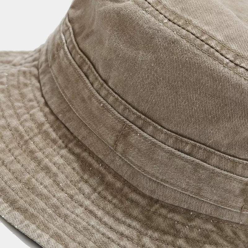 Close-up of the crown seams and wide stitched brim on the khaki bucket hat