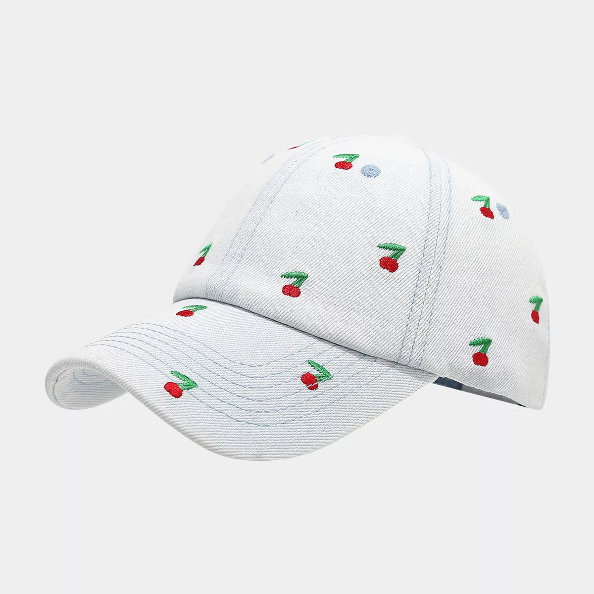White denim baseball cap with small red cherry embroidery