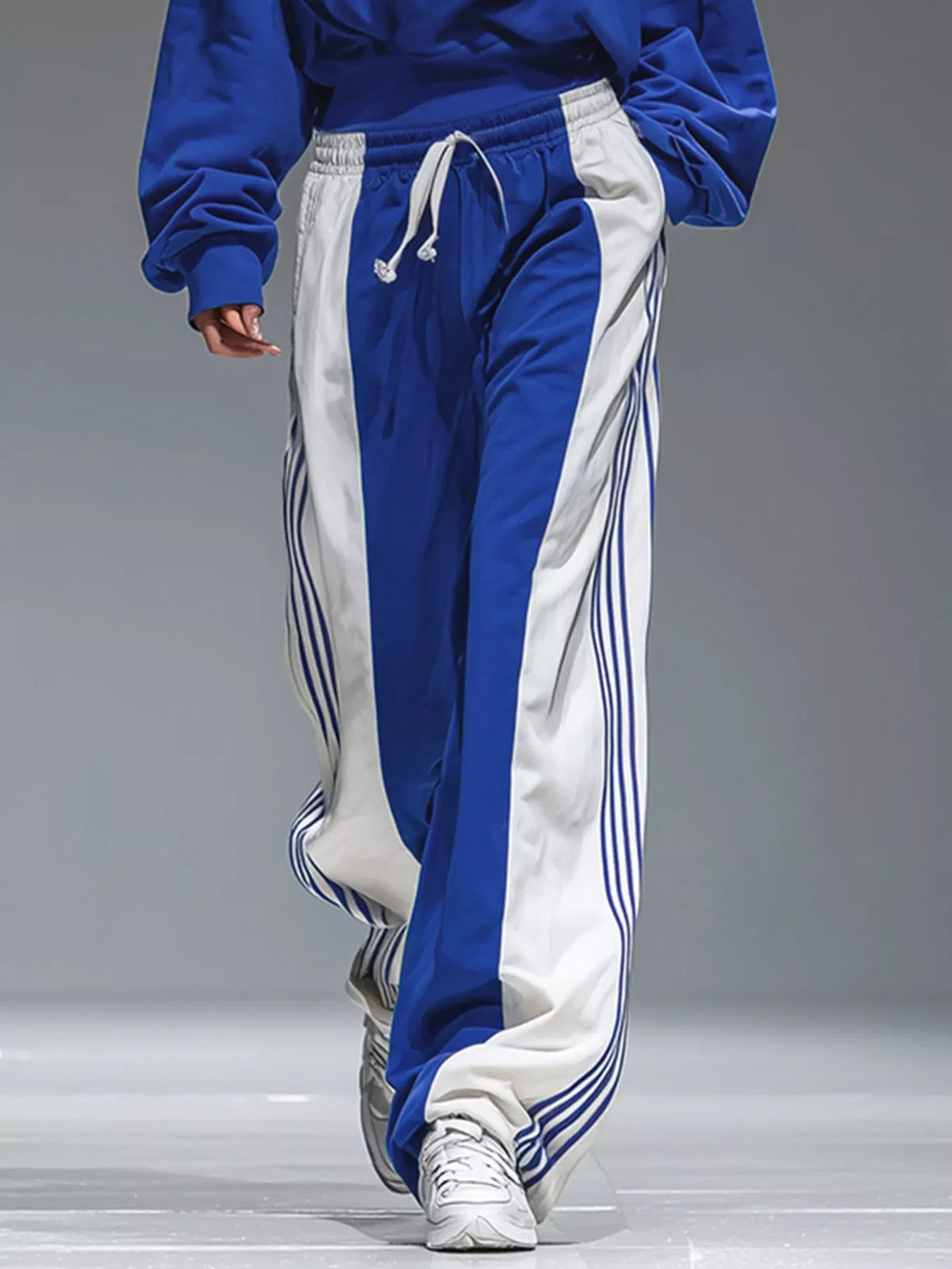 Lower view of the blue-and-white pants showing white side panels and narrow blue stripes.