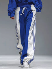 Lower view of the blue-and-white pants showing white side panels and narrow blue stripes.