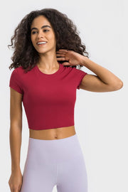 Model wearing a burgundy cropped sports T-shirt with lavender leggings