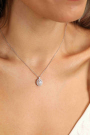 Model wearing an oval clear-stone pendant necklace