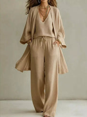 Woman modeling the beige V-neck cardigan set with matching pants.