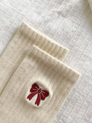 Close-up of the embroidered bow on ribbed fabric