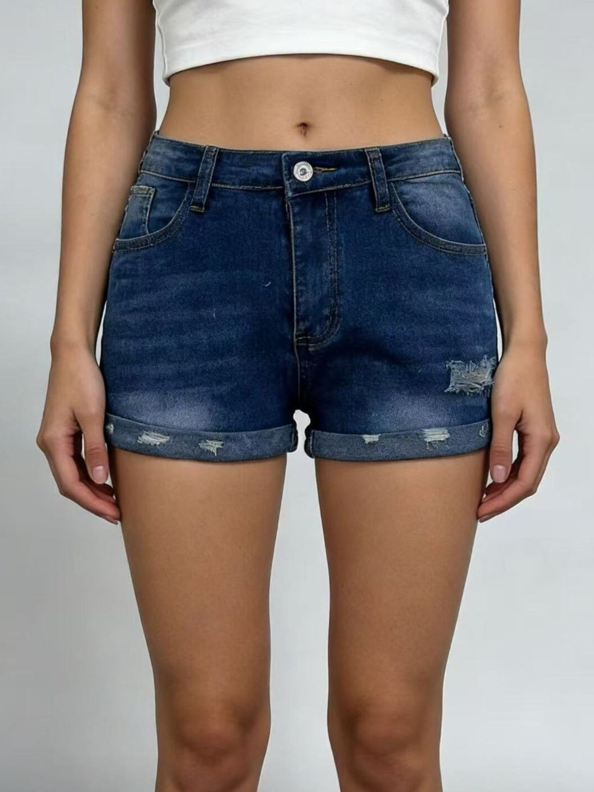 Front view of blue denim shorts with rolled cuffs
