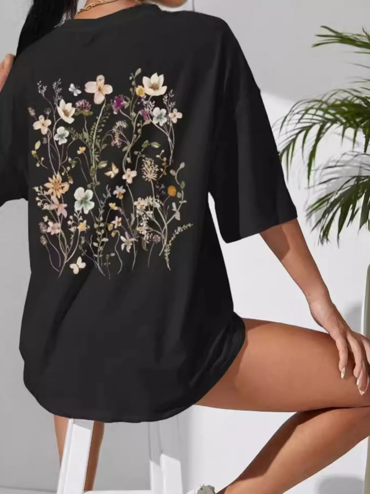 Black oversized tee with large multicolored wildflower print on the back