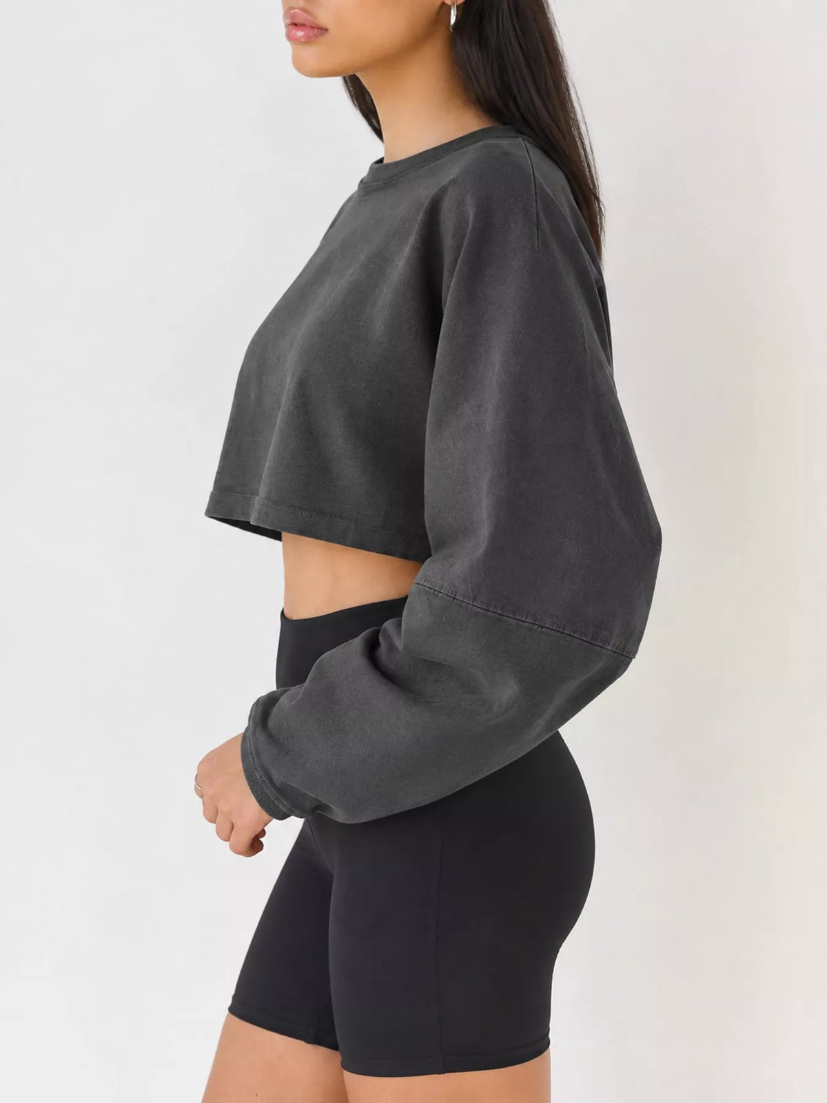 Side view of charcoal cropped sweatshirt with long sleeve