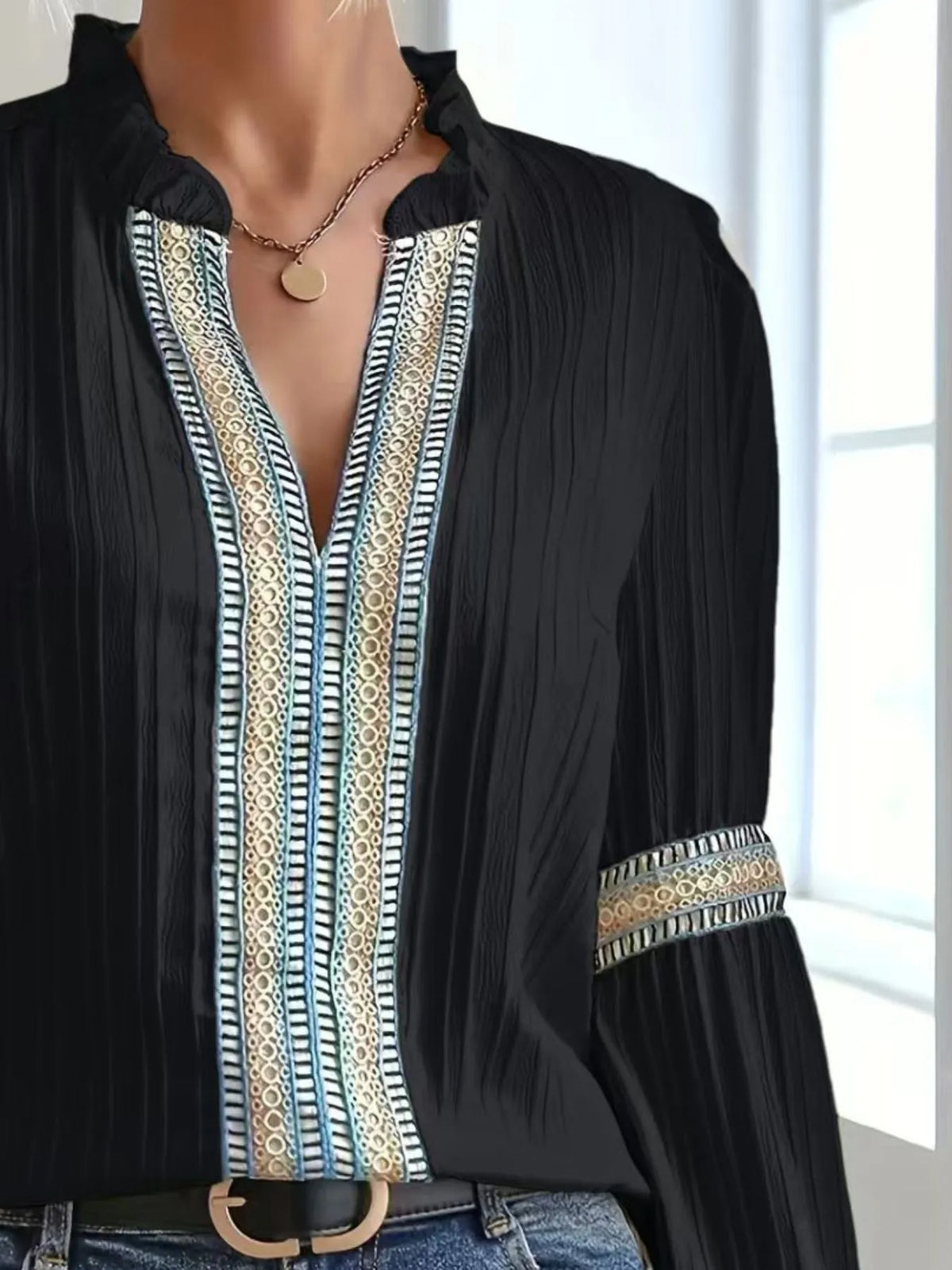 Notched textured balloon-sleeve blouse in black front view with handbag