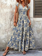 Purple floral maxi dress with a thigh-high slit, modeled with the skirt held aside.