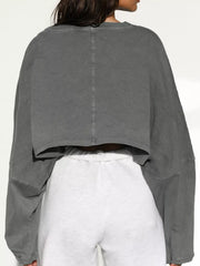 Back view of gray cropped sweatshirt showing center seam and cropped hem