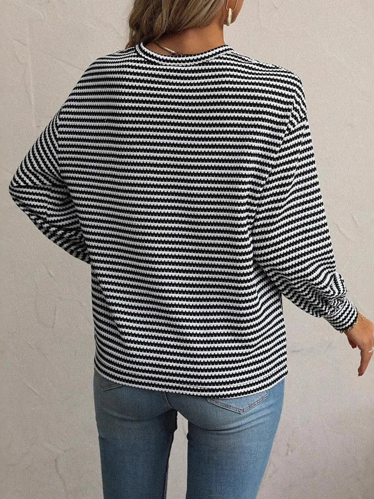 Back view of black-and-white striped top