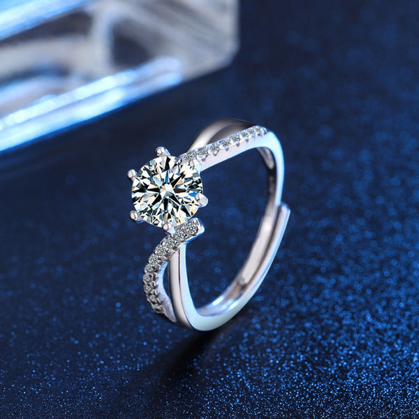 Round clear moissanite ring with pavé band on blue display surface