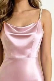 Detail of the blush pink satin cowl neckline and pearl strap.