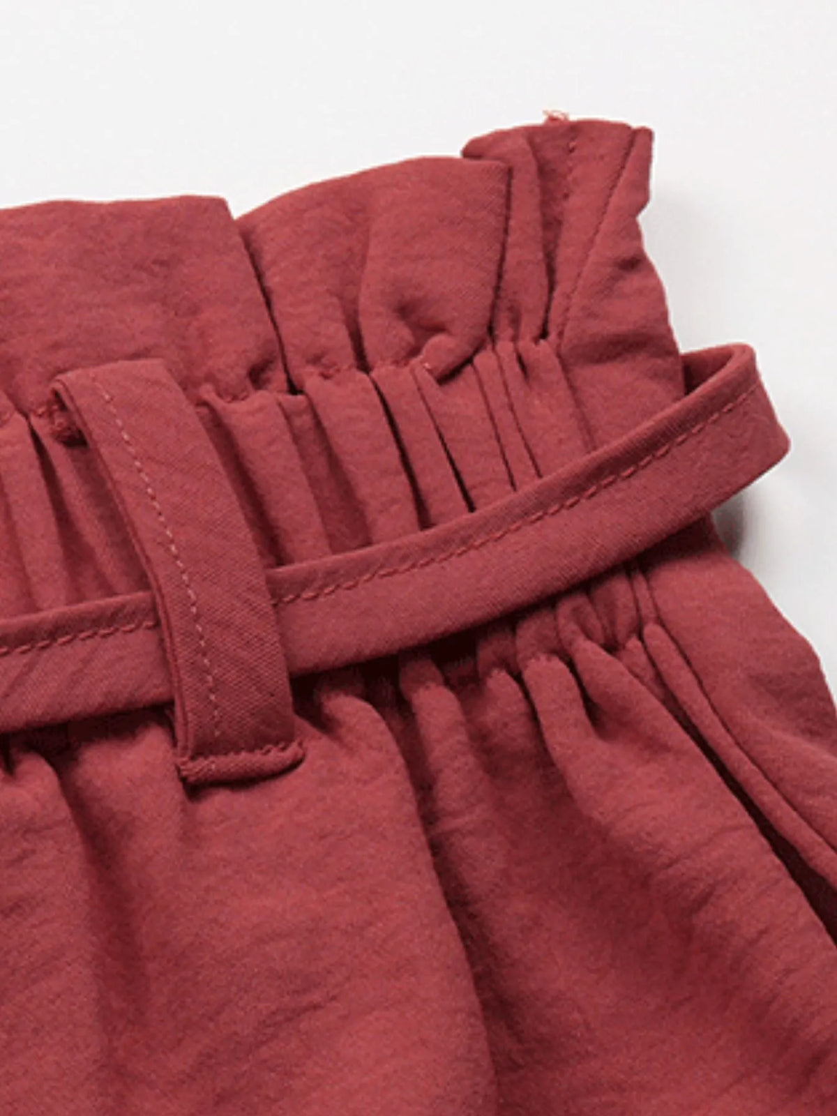 Detail of rose shorts' paperbag waist and tied belt