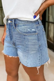 Side view of light-wash high-waisted denim shorts with frayed hems