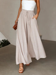 Model wearing pale beige high-waist wide-leg pants
