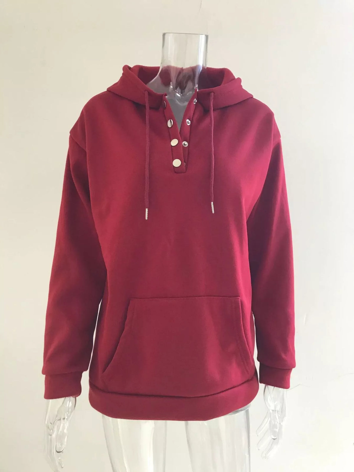 Women’s plus-size kangaroo-pocket drawstring hoodie in wine-red front view on hanger