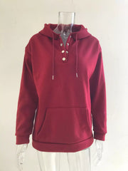 Women’s plus-size kangaroo-pocket drawstring hoodie in wine-red front view on hanger