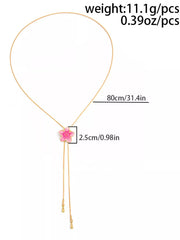 Gold-tone lariat necklace with pink flower and length measurement graphic
