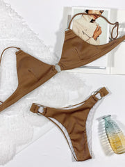Brown ribbed triangle bikini and matching high-cut bottoms with ring details laid flat