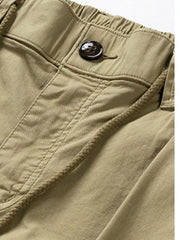 Close-up of khaki cargo pants waistband, button and stitching
