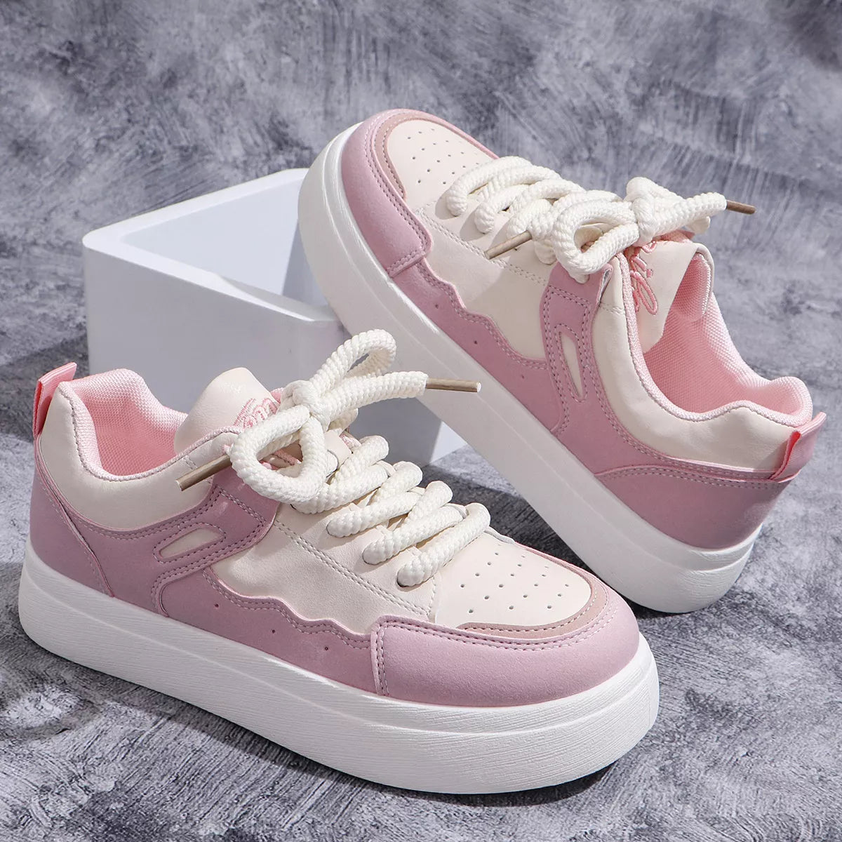 Pink and white platform sneaker side view