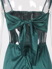 Close-up of green maxi dress with draped front and high slit
