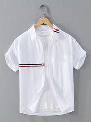 Back view of white short-sleeve shirt with red and navy collar stripe detail