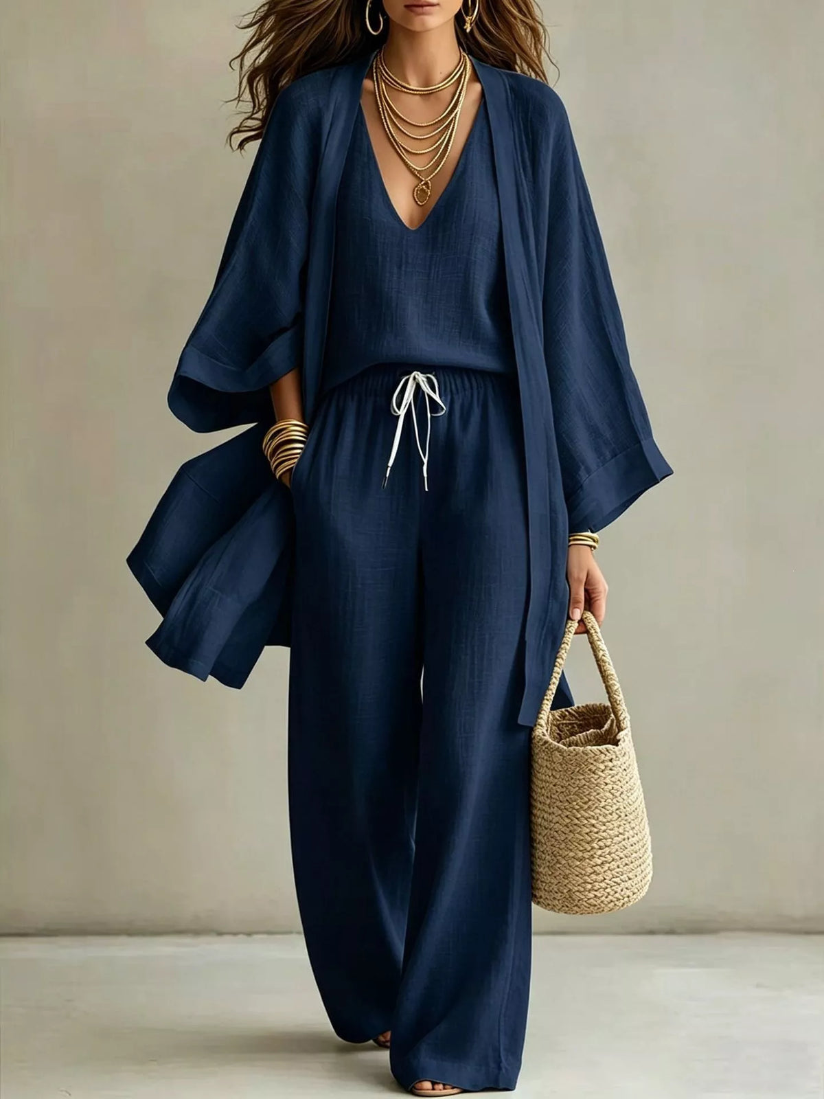 Woman wearing the navy cardigan and pants set with a tied waist.