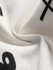 Close-up of white denim fabric with black printed marks