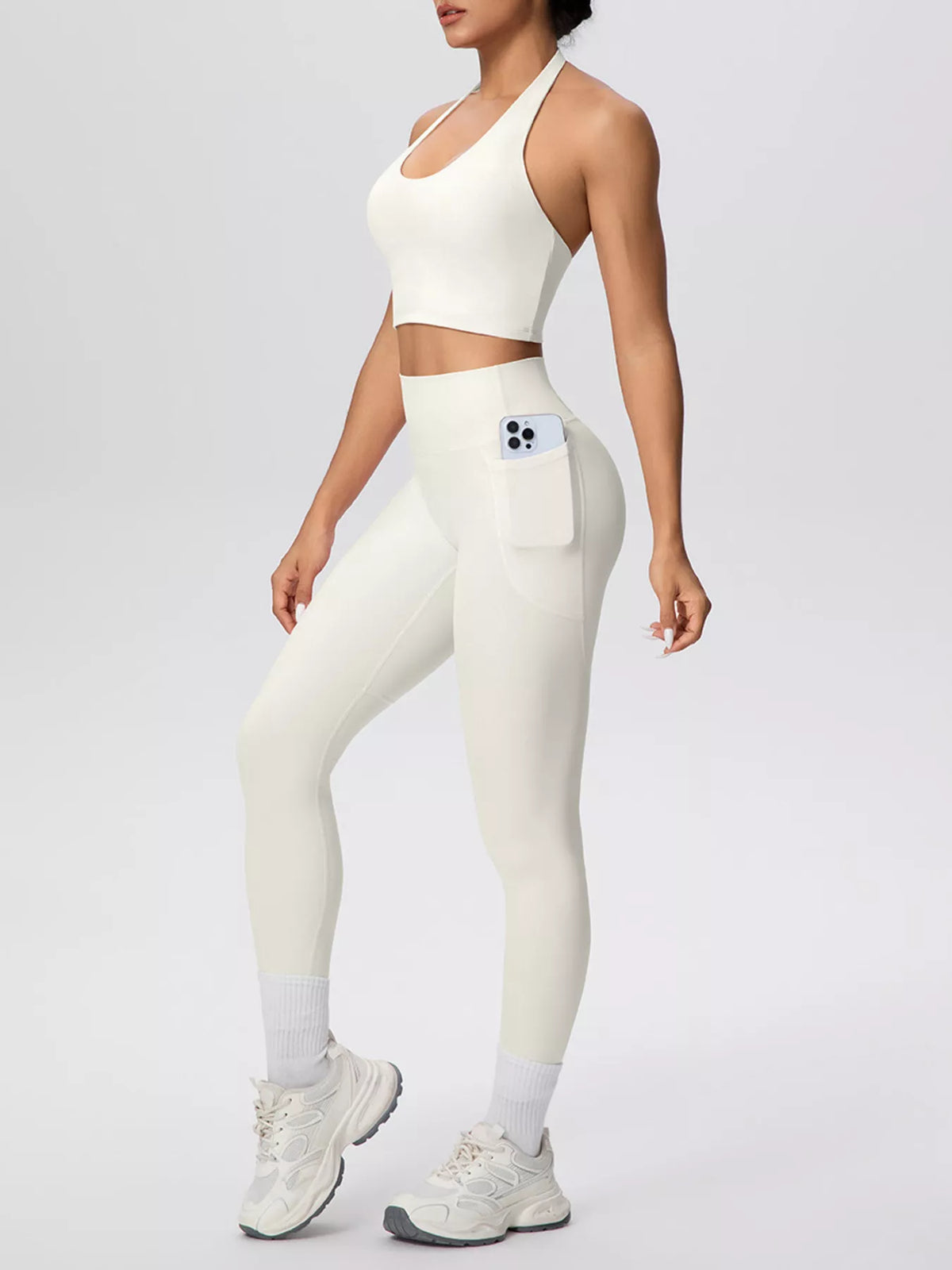 White halter set shown at an angle with phone pocket in leggings