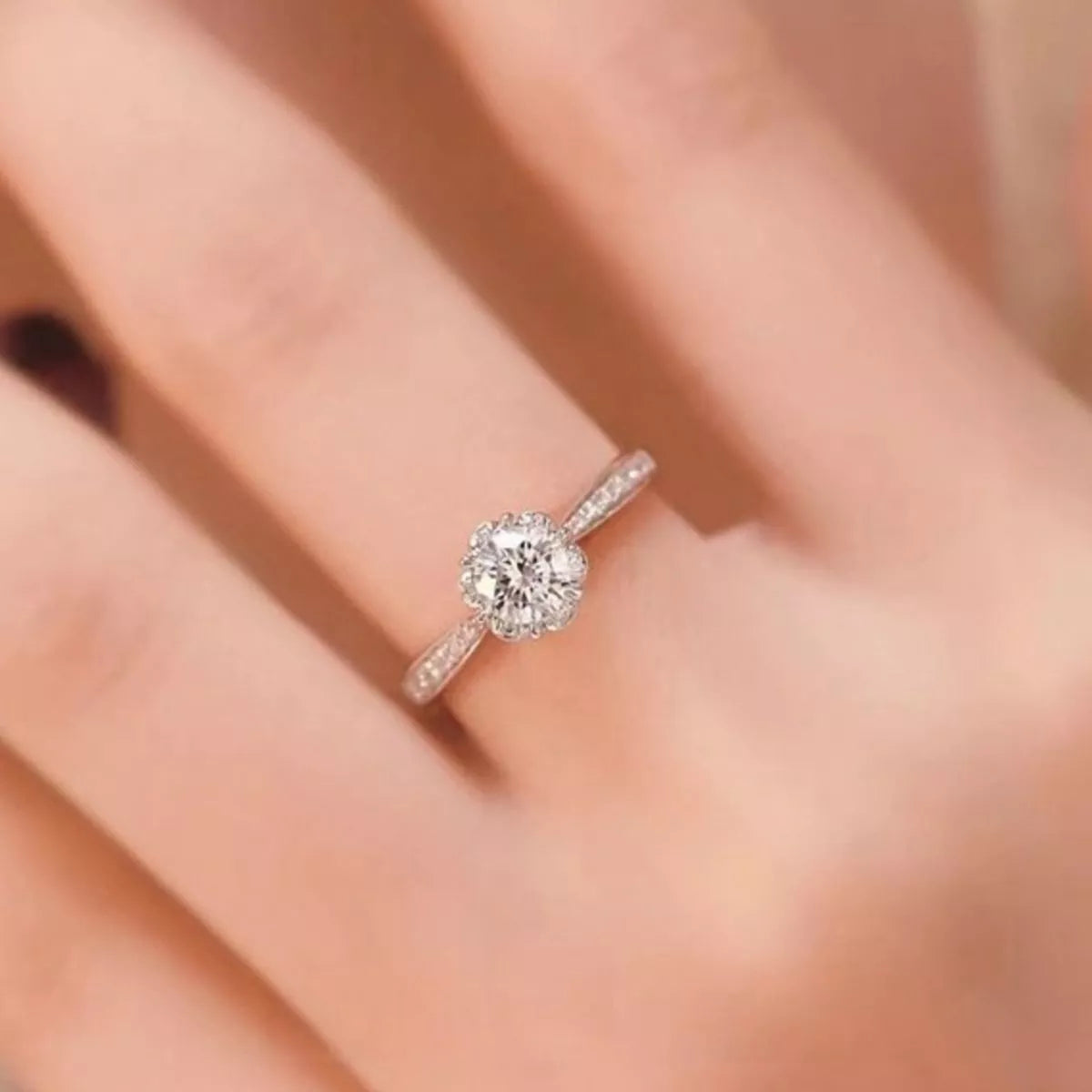 Close-up of round moissanite solitaire ring on a finger