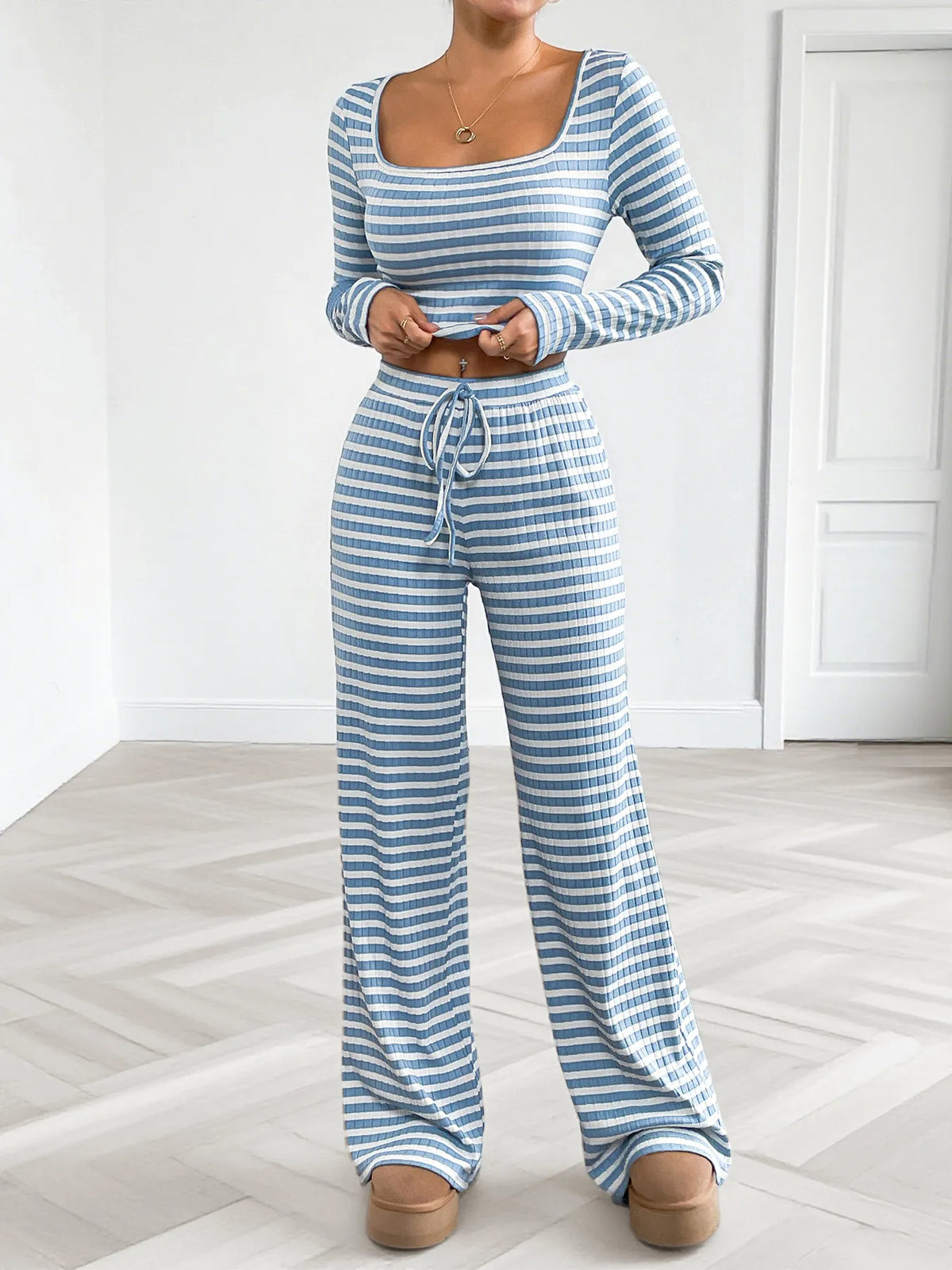 Model wearing matching blue striped square-neck top and wide-leg lounge pants