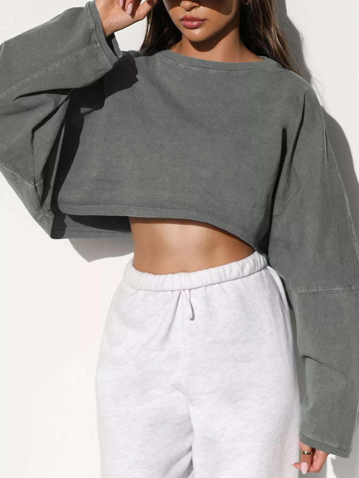 Front view of gray cropped sweatshirt with oversized sleeves