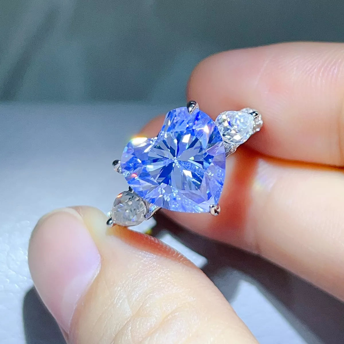 Close view of the blue heart centre stone and clear side stones.