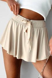 Ivory high-waist skort with elastic drawstring waistband, shown from front.