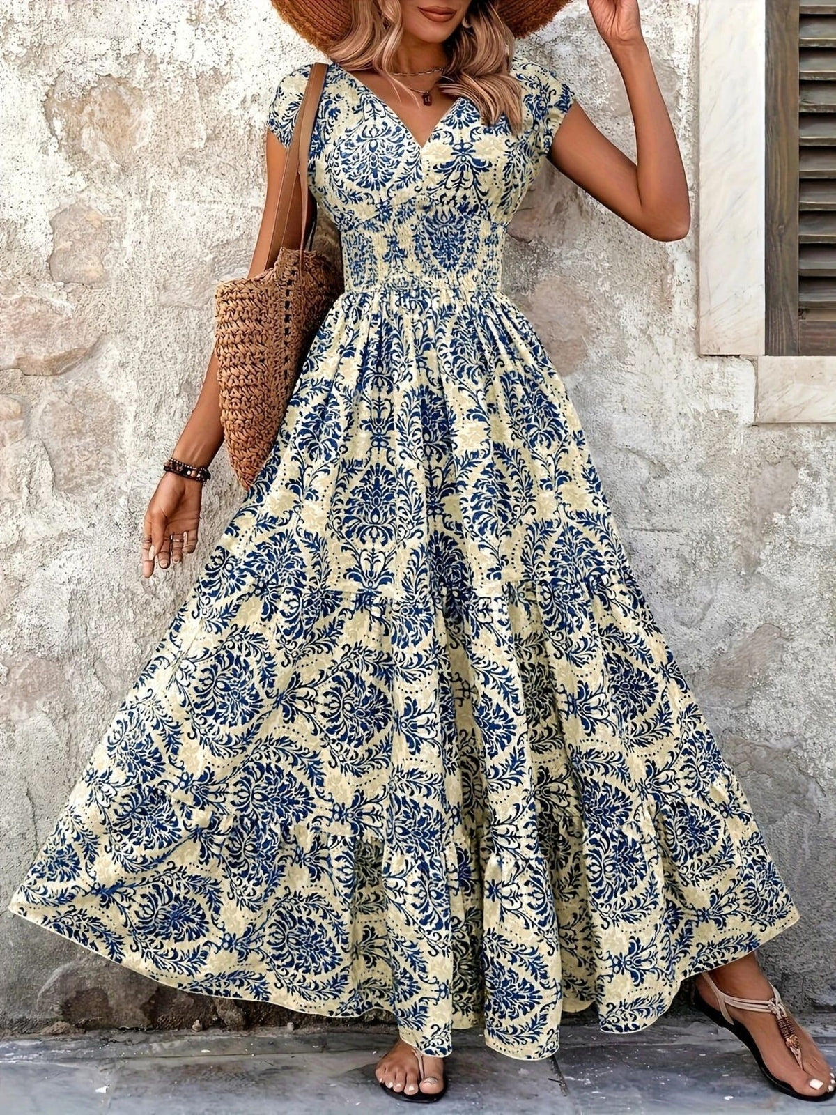 Red floral cap-sleeve maxi dress modeled with its full skirt spread outward.