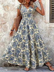Red floral cap-sleeve maxi dress modeled with its full skirt spread outward.