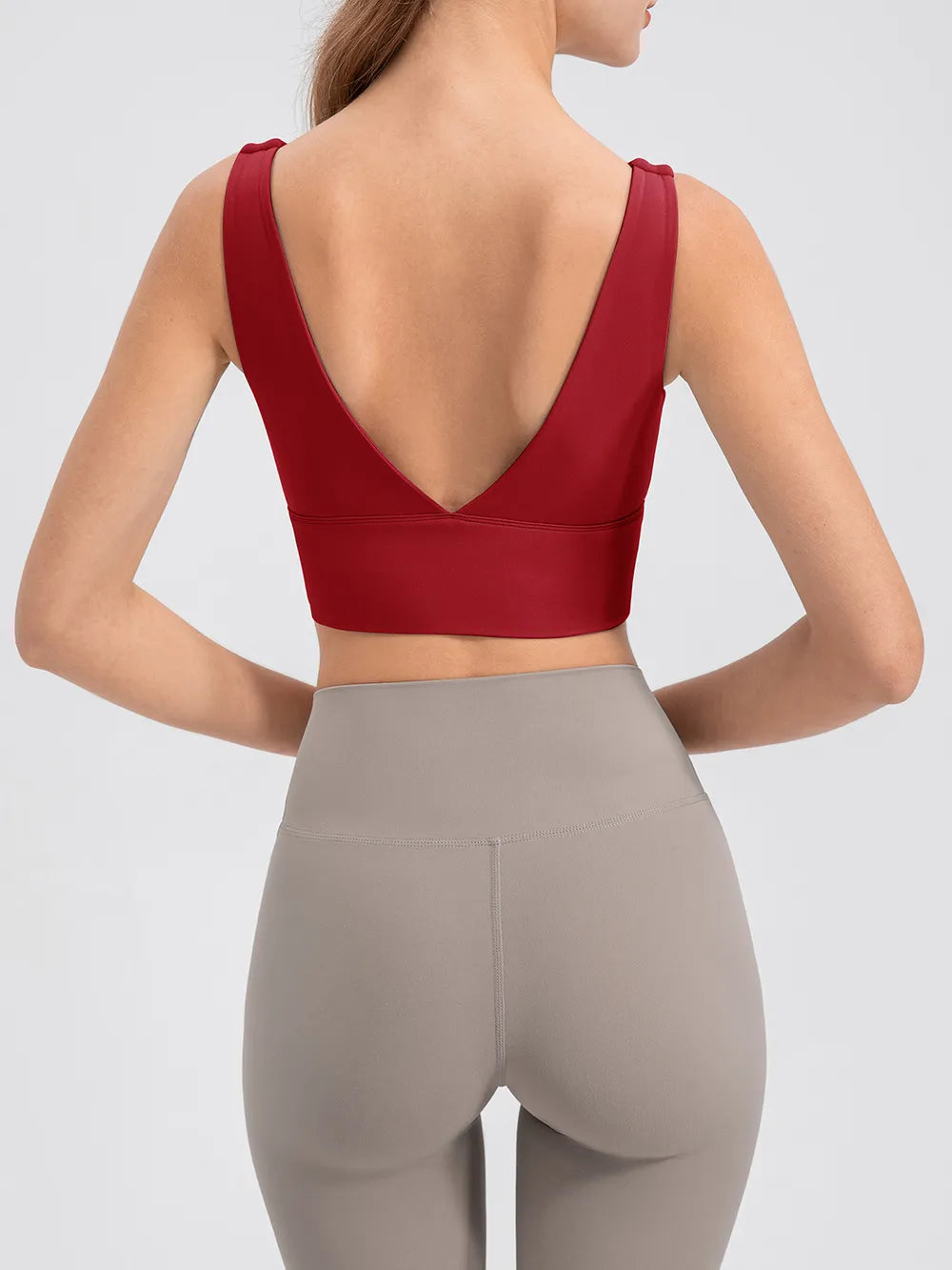 Back view of red cropped tank showing deep V neckline