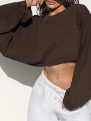 Close view of dark brown cropped sweatshirt front and sleeve