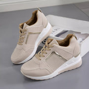 Pair of beige lace-up wedge sneakers, side view