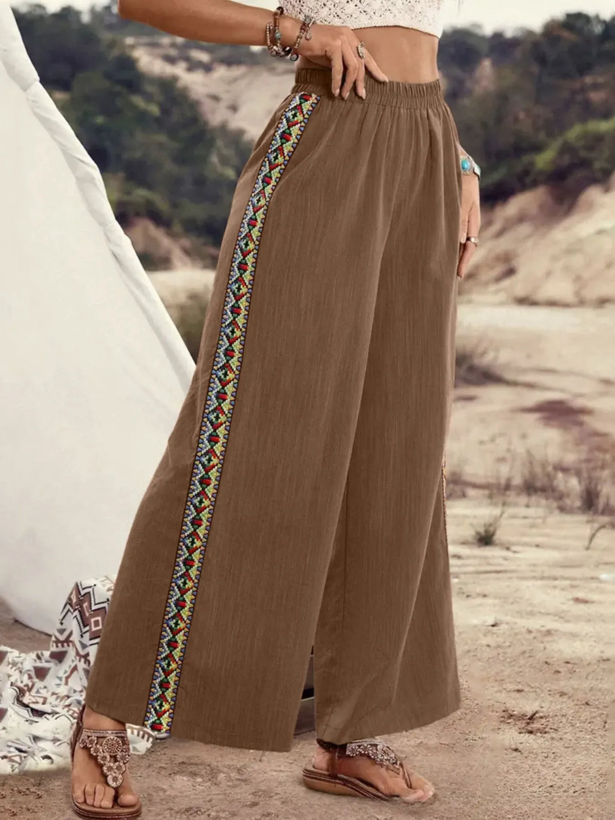 Brown wide-leg pants with embroidered side stripes, full-length view