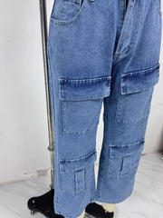 Close-up of cargo jeans leg with layered flap pockets