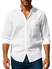 Men’s white button-up shirt styled with sleeves rolled and dark jeans
