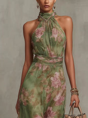 Close view of the floral maxi dress's halter neckline and fitted bodice.